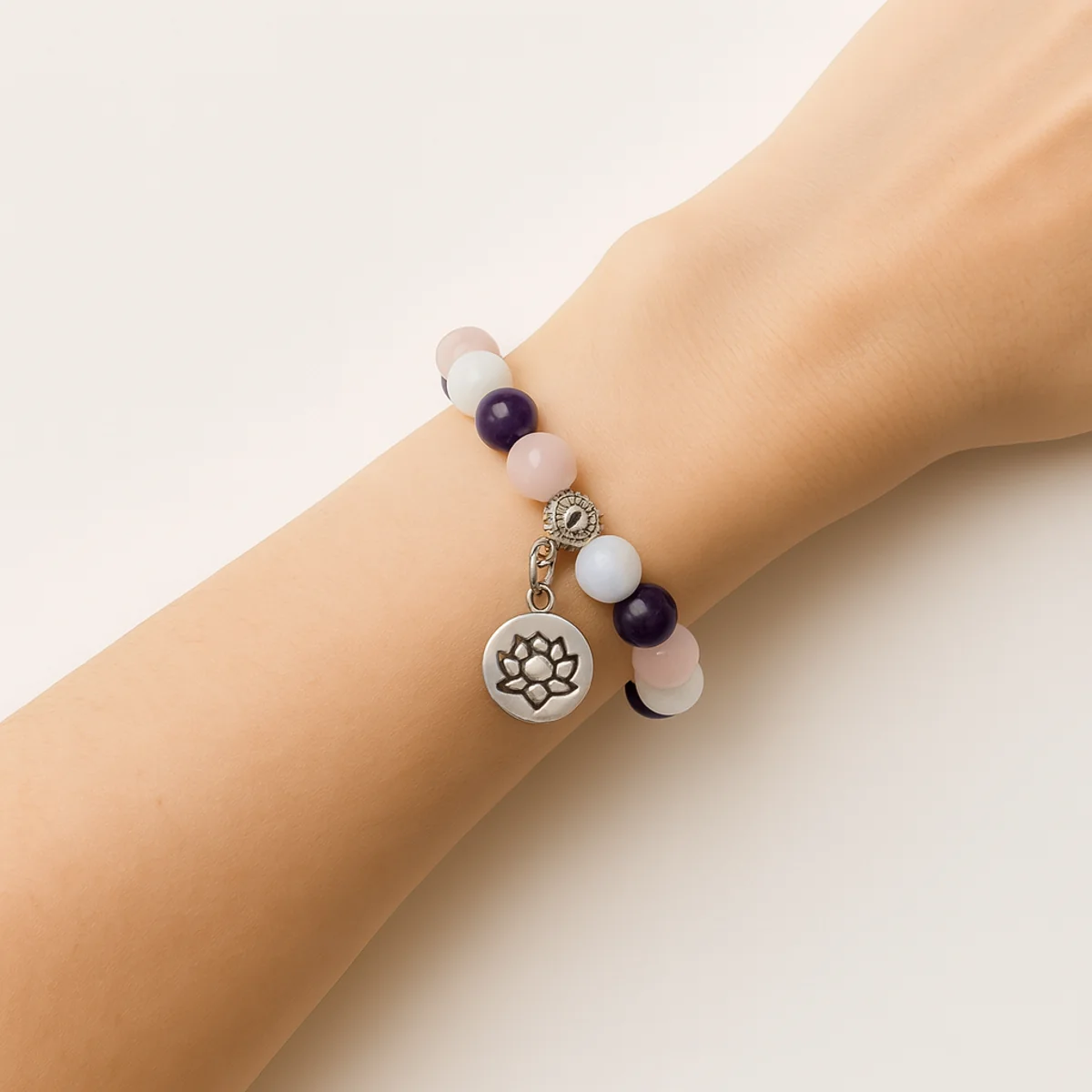 Bracelet Sommeil Apaisement porté au poignet, composé de quartz rose, améthyste et pierre de lune.