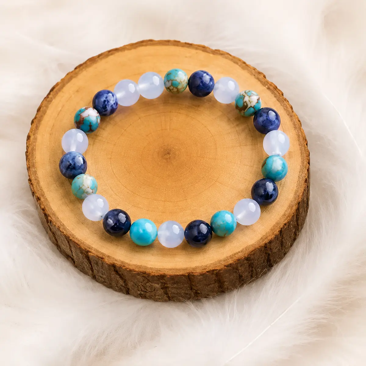 Bracelet Sodalite Calcédoine Turquoise Harmonie et Expression présenté sur un rondin de bois