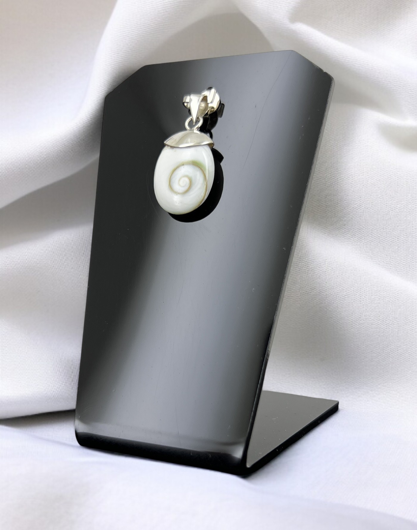 Apportez élégance et protection avec le pendentif Œil de Sainte Lucie. Ce bijou coquillage méditerranéen porte chance, éloigne le mauvais œil et séduit par ses nuances naturelles blanches et orangées. Un accessoire raffiné et chargé d’énergie positive.