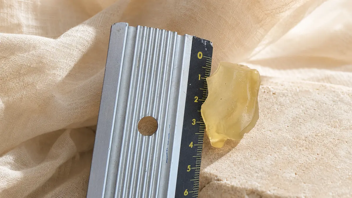 Tectite dorée rare en verre du désert de Libye avec règle graduée